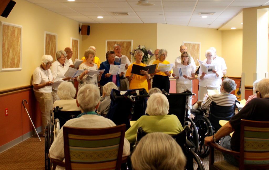 Saint Peter's Lutheran choir members singing for assisted living residents