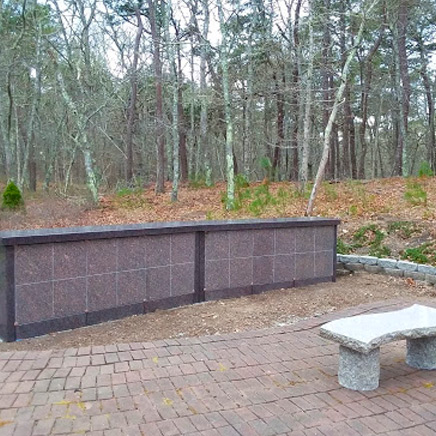 Memorial garden monument with bench in front